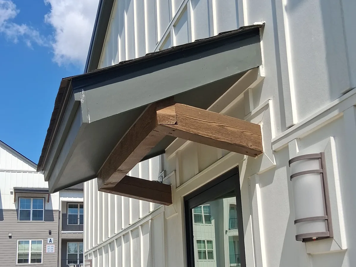 Painted board-and-batten exterior with a small entry roof