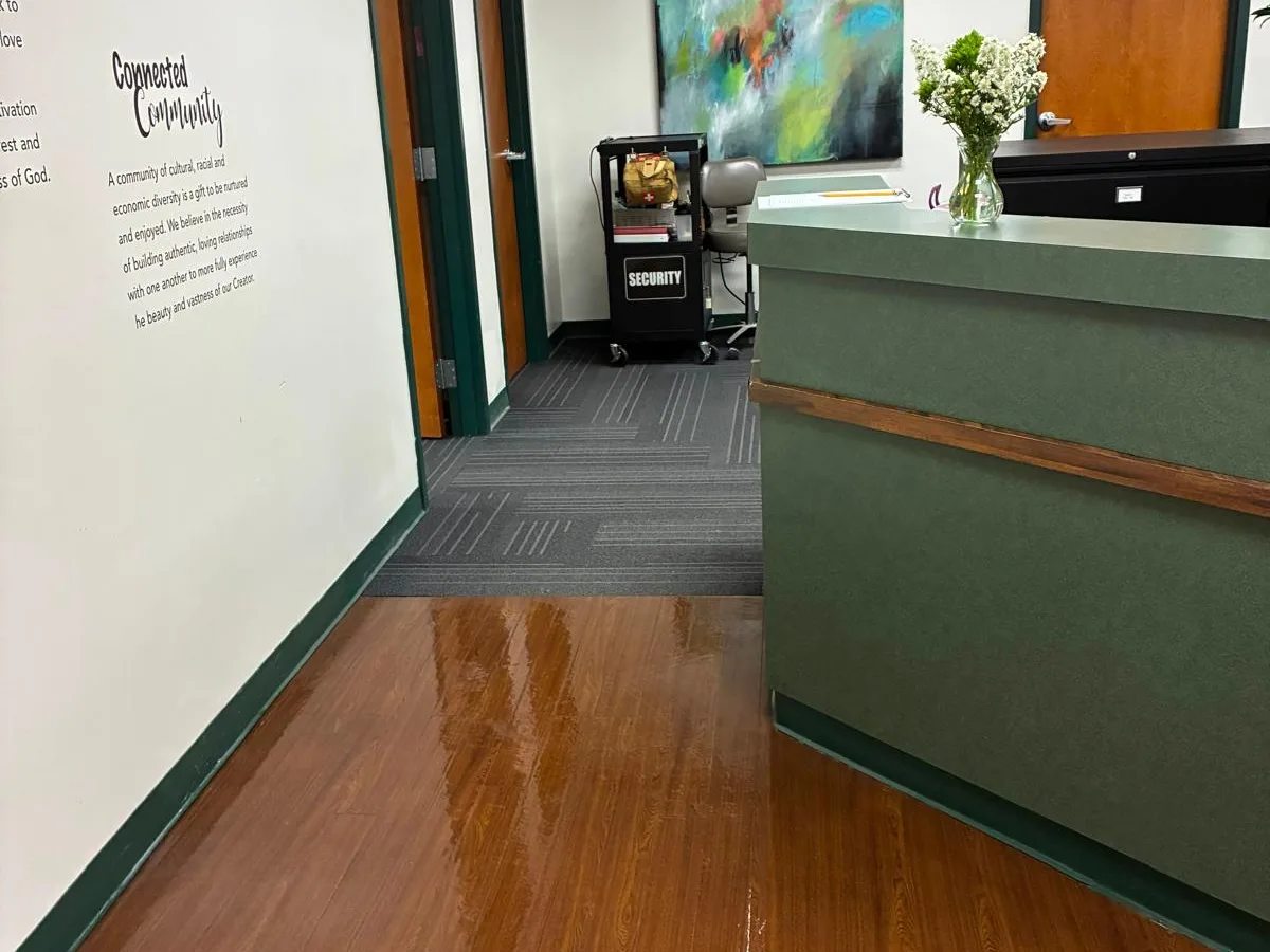Office hallway with polished wood floors and a reception desk